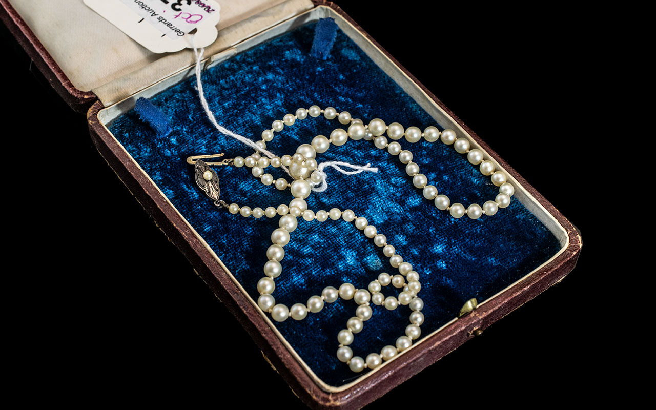 String of Cultured Pearls Necklace with Silver Clasp, Which Is Stamped Silver. Length 20 Inches.