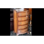 Small Chest of Five Drawers, with decorative pull handles. Raised on four ball feet.