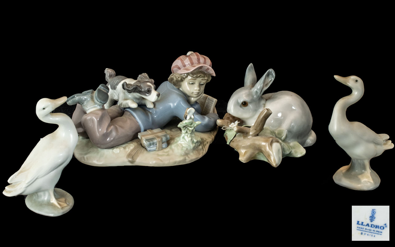 Four Lladro Figures, comprising two geese, a bunny rabbit and a boy reading with a puppy No. 5451.