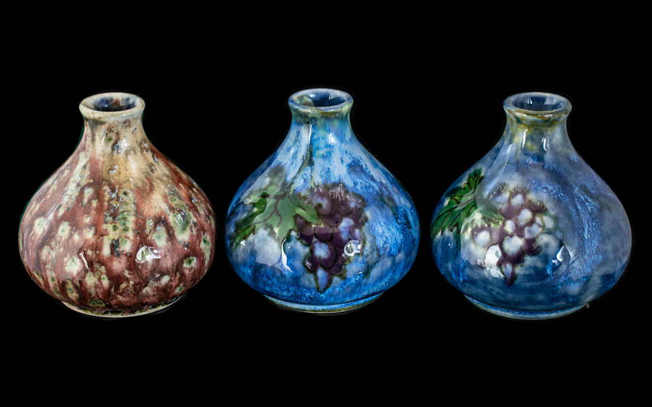 Three Small Cobridge Vases, a pair decorated with oak leaves and berries, and one mottled design.