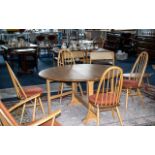 An Ercol Blonde Beech/Elm Dining Table and Four Chairs Circular Drop Leaf Dining Table With Four