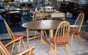 An Ercol Blonde Beech/Elm Dining Table and Four Chairs Circular Drop Leaf Dining Table With Four
