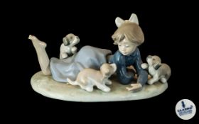 Lladro Figure No. 5.594 'Playful Romp' depicting girl with puppies.