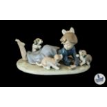 Lladro Figure No. 5.594 'Playful Romp' depicting girl with puppies.