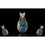 A Superb 18ct Gold Large Black Opal and Diamond Set Pendant. Marked 750 - 18ct.