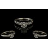 A 9ct White Gold Diamond Ring, set with a central diamond cluster, diamond set shoulders,