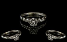 A 9ct White Gold Diamond Ring, set with a central diamond cluster, diamond set shoulders,