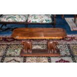 A Early 20th Century Coffee Table Shaped Rectangular Top Raised On Carved Elephant Supports With