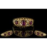 18ct Gold Antique Ruby & Diamond Ring, set with three rubies between diamond set spacers,