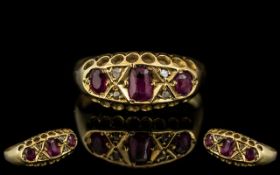 18ct Gold Antique Ruby & Diamond Ring, set with three rubies between diamond set spacers,