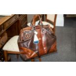 A Brown Leather Holdall In Two Tone Brown Leather With A Concord Tag.