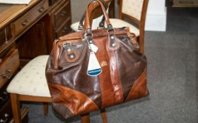 A Brown Leather Holdall In Two Tone Brown Leather With A Concord Tag.