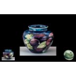 W. Moorcroft Small Pansies Vase on Blue Ground of Globular Form. Height 2,5 Inches - 6,25 cms.