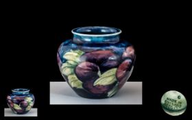 W. Moorcroft Small Pansies Vase on Blue Ground of Globular Form. Height 2,5 Inches - 6,25 cms.