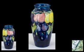William Moorcroft Signed Small Vase ' Wisteria ' Plums Design on Blue Ground. c.1920 - 1925.
