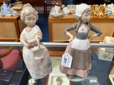 Lladro Dutch Girl Figurine, No. 5064, 11'' tall, together with a Lladro Nao figure girl with basket,