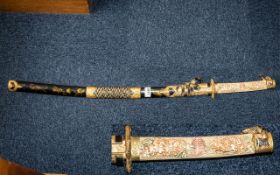 Decorative Oriental Style Fantasy Display Cutlass with carved handle decorated in gold, in sheath.