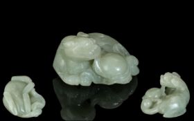 A Chinese Carved 18th / 19th Century Jade Sculpture of a Recumbent Foo Dog with Ball.