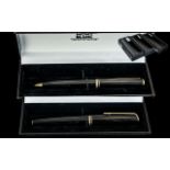 A Mont Blanc Fountain Pen, black barrel and cap, gold tone clip and bands, 14ct gold nib.