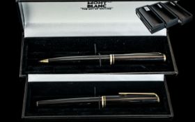 A Mont Blanc Fountain Pen, black barrel and cap, gold tone clip and bands, 14ct gold nib.