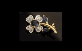 9ct Gold Diamond & Sapphire Brooch, in the form of a flower, diamond petals.