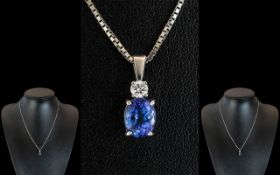 Ladies 18ct White Gold Pendant Set with a Tanzanite & Diamond, attached to a 9ct white gold chain.