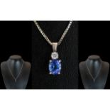 Ladies 18ct White Gold Pendant Set with a Tanzanite & Diamond, attached to a 9ct white gold chain.