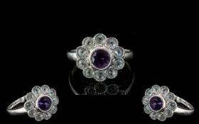 9 ct Gold Amethyst Set Dress Ring, flower head setting set with white sparkly stones.