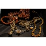 Collection of Amber Coloured Jewellery, including necklaces, bracelet and ring.