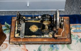 Vintage Jones Family CS Sewing Machine, hand shank, black with gold and red decoration.