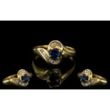 18ct Gold Sapphire & Baguette Cut Diamond Ring, central Sapphire between channel set baguettes.