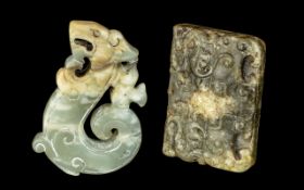 A Pair of Jade Amulets in the archaic style, one in the form of a dragon 2.5" x 1.