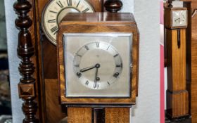 Art Deco Granddaughter Clock, teak casing, square silver face, Roman numerals. Measures 9'' wide x