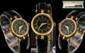 Gucci Ladies Gold Plated Quartz Wrist Watch, model No. 0000107, with display box and papers.