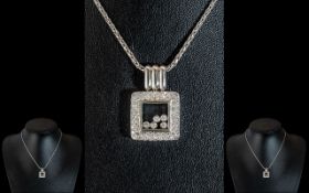 An 18ct White Gold Pendant & Chain, in the style of Chopard floating diamonds style,