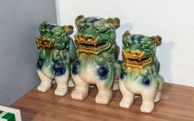 Three Oriental Foo Dogs, one 10" tall and a pair 9" tall.
