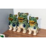 Three Oriental Foo Dogs, one 10" tall and a pair 9" tall.