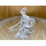 Swarovski Interest. ' Ballerina ' In a Sitting Position doing her laces and her Ballet Shoes.