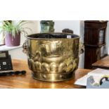 Large Brass Planter, decorated with nautical scenes, with twin lion's head handles. Measures 13.