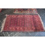 Two Wool Rugs, both with signs of wear, traditional wool rug border pattern with central diamond