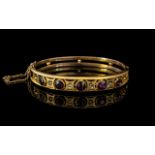 Ladies 9ct Gold and Garnet and Diamonds Bangle With Safety Chain. Approx Size 6.5 by 5 cms.