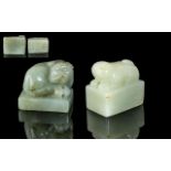 A Pair of Two Jade Seals both surmounted by stylised beasts with Archaic script to base.