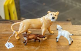 Three Beswick Figures, comprising a lioness measuring 6" tall x 9" long, a fox measuring 2.