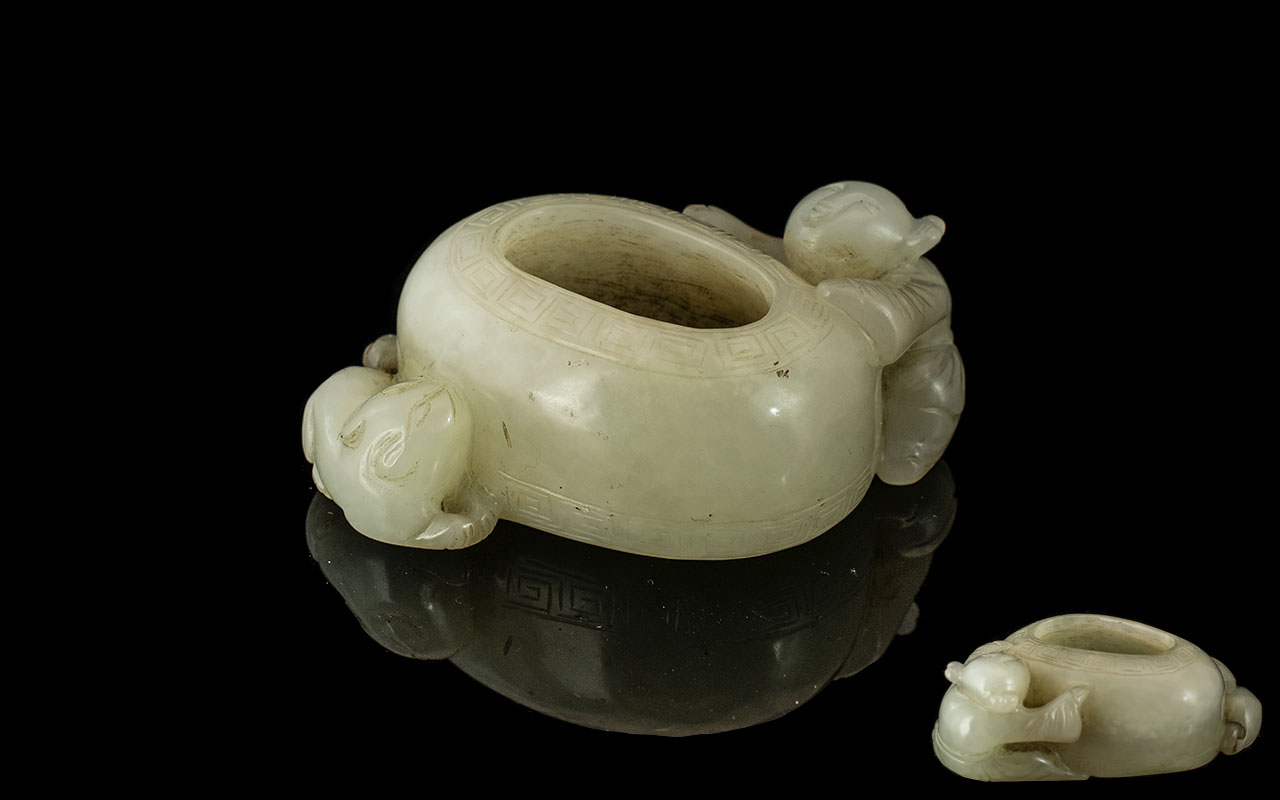 A Brush Pot in White Jade depicting a bo