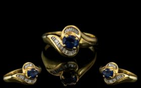 18ct Gold Sapphire & Baguette Cut Diamond Ring, central Sapphire between channel set baguettes. Ring