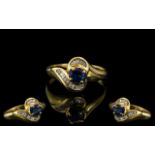 18ct Gold Sapphire & Baguette Cut Diamond Ring, central Sapphire between channel set baguettes. Ring