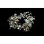 A Superb Vintage Sterling Silver Charm Bracelet, loaded with over 30 silver charms, all marked for