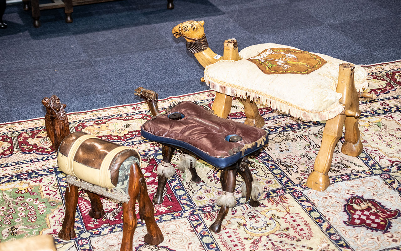 A Collection Of Three Camel Stools All Three Of Various Designs Of A Wooden Construction With Padded