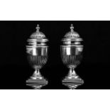 A Fine Pair of Sterling Silver Pepperettes of Classical Form, with reeded bodies, standing on