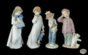 Four Nao Figures, depicting children with their toys, comprising a girl with a clown, and boy with a